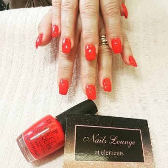 red acrylic nails at the Nails Lounge in Bishop's Stortford